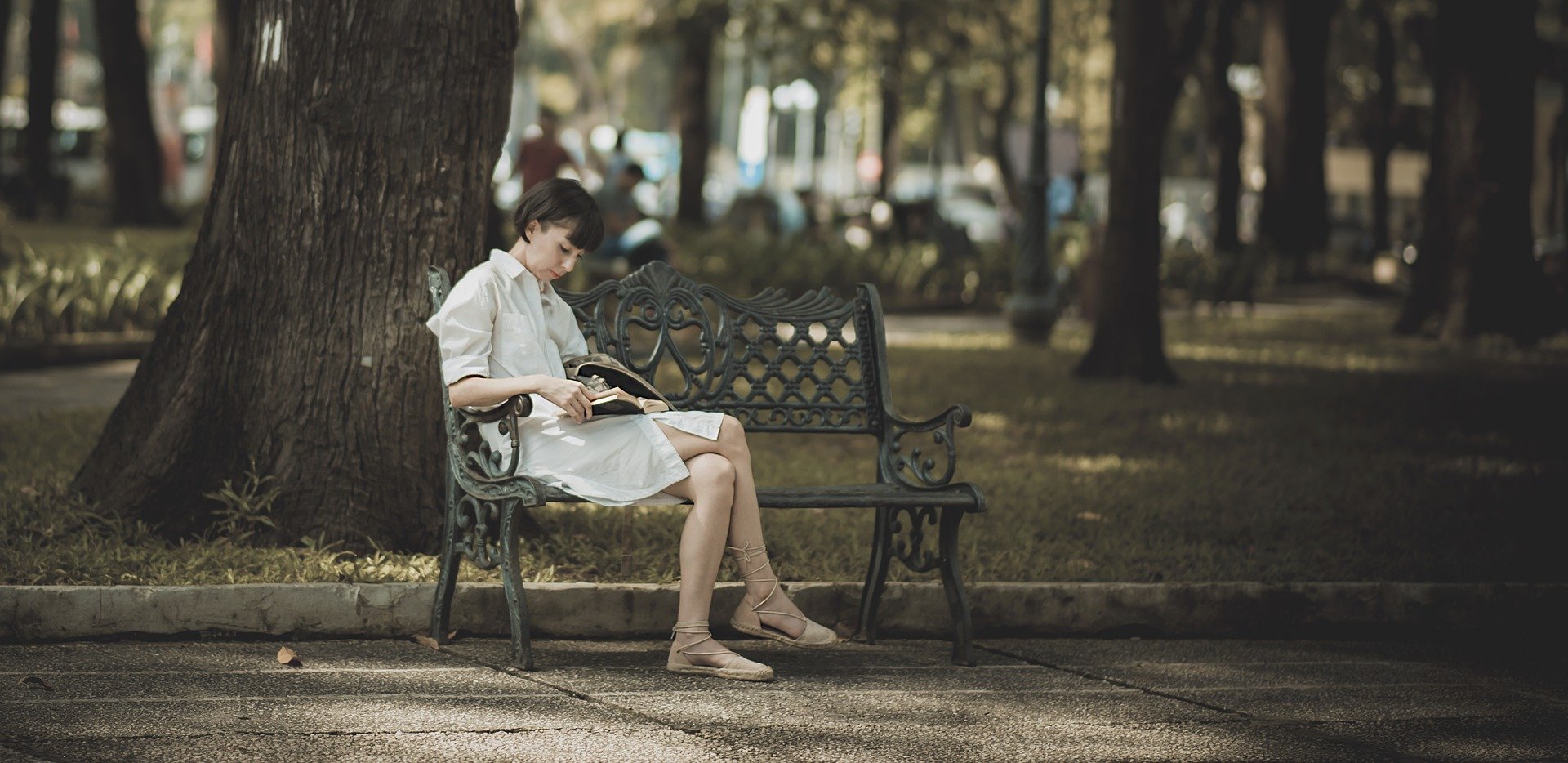 girl reading on bench
